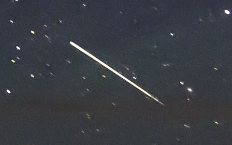 A meteor: a short bright streak, fat in the middle and thin at both ends