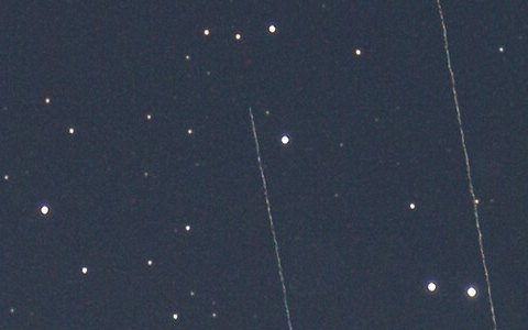 Before: two long, thin Starlink trails cross a field of stars