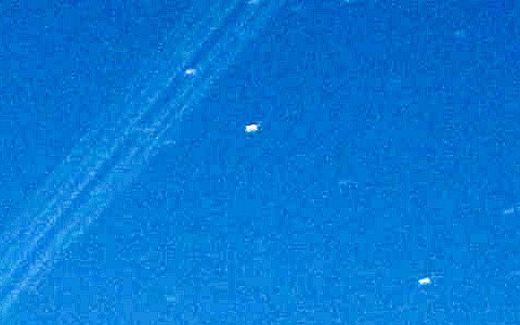 Before: several faint, parallel Starlink trails close together on a blue twilight sky